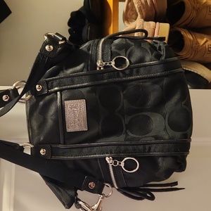 Black coach bag, zipper closure with handles and a strap